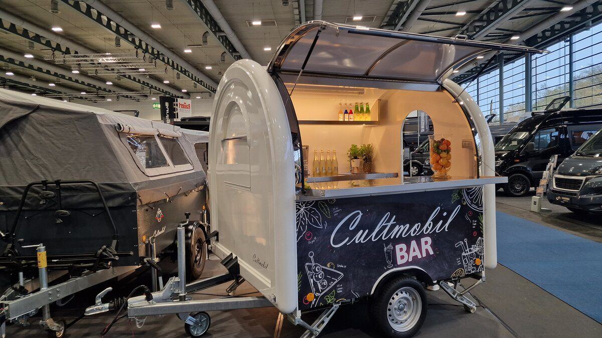 Weißer Retro-Foodtrailer als Bar in einer Ausstellungshalle